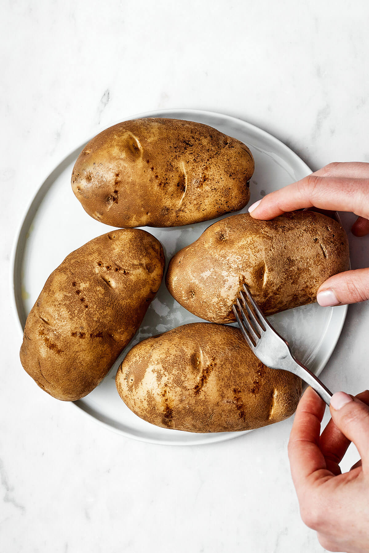 Poking holes in potatoes with a fork