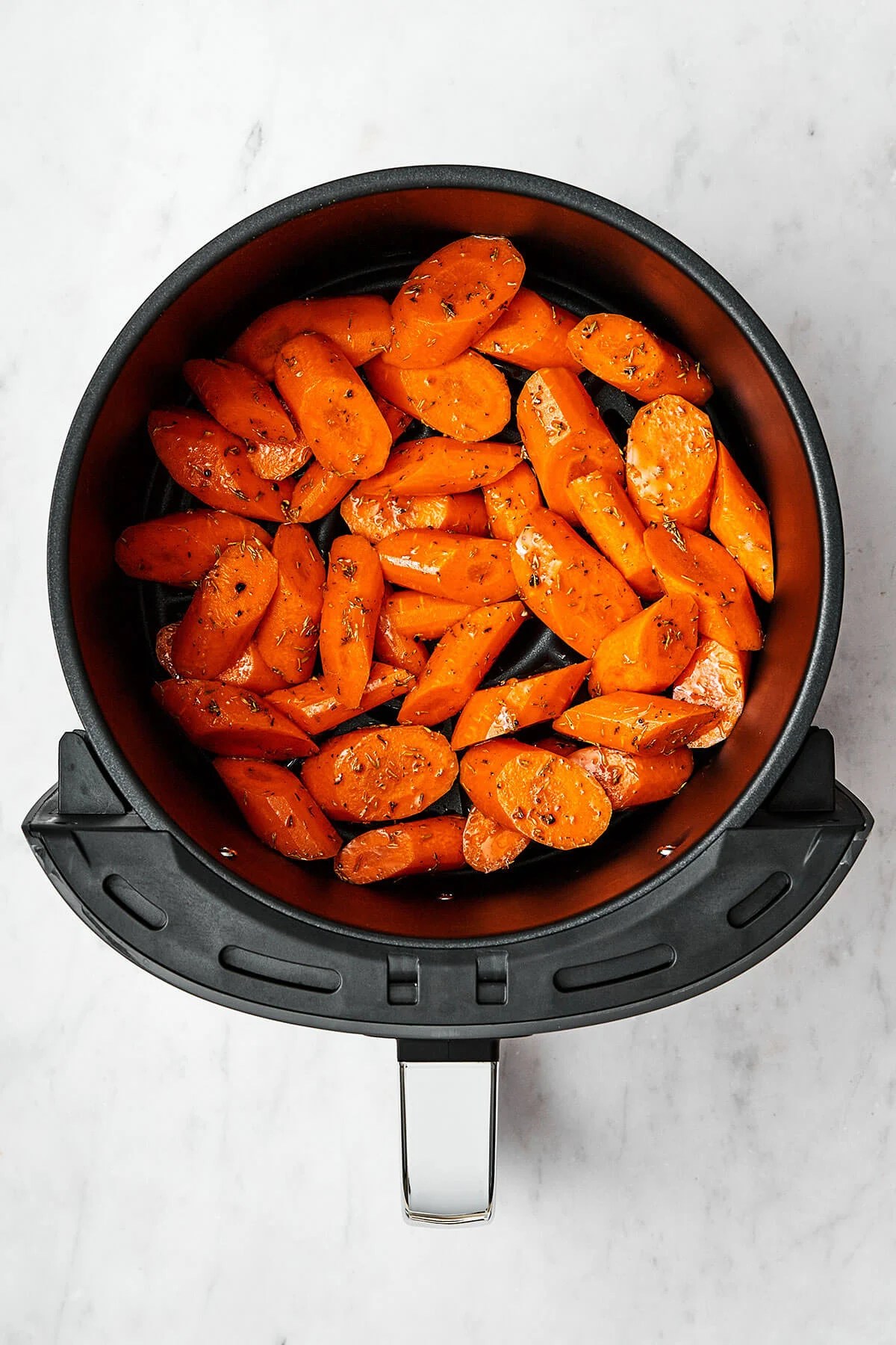 Placing carrots into the air fryer