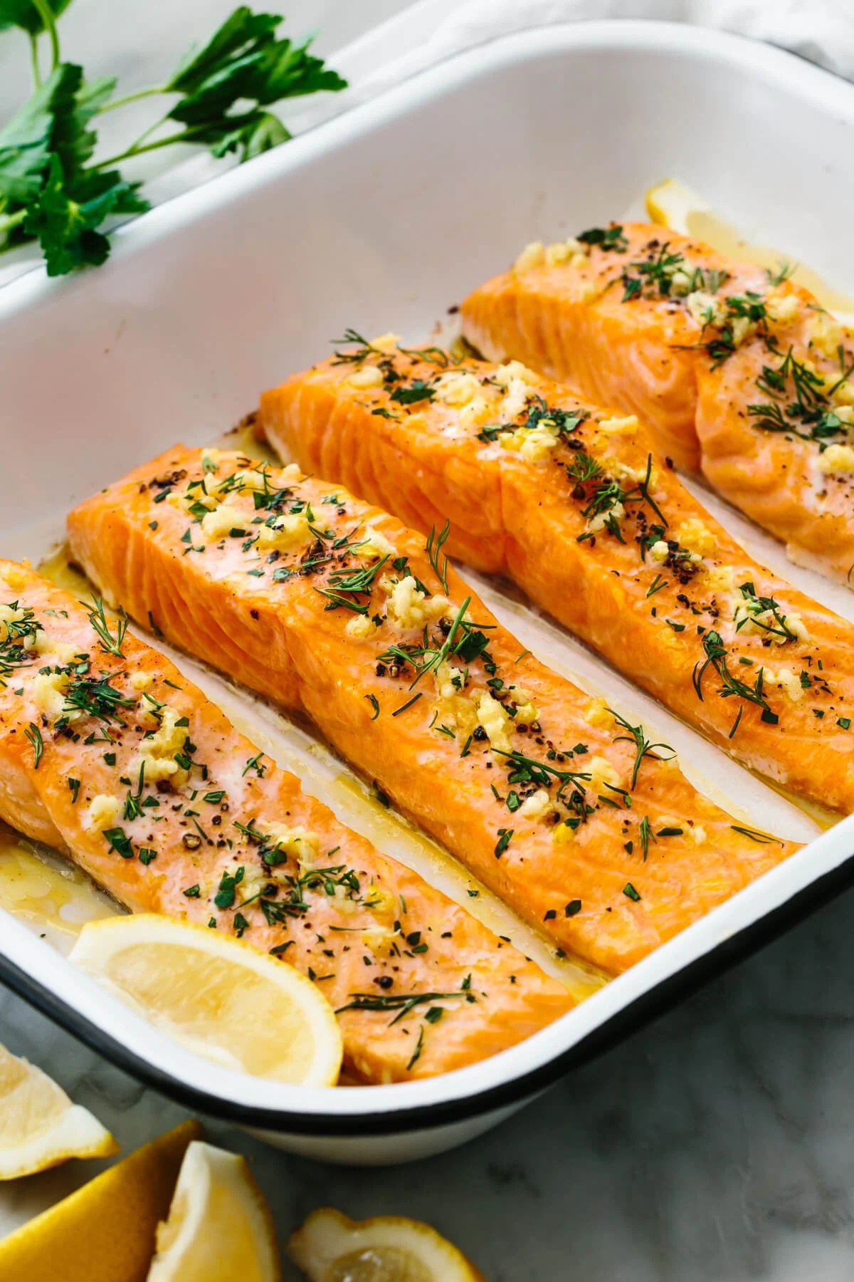 A white baking dish of baked salmon.