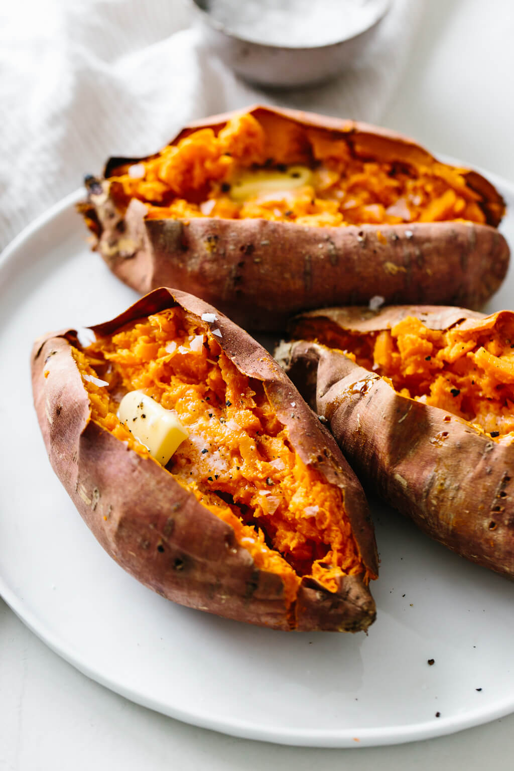 Learn how to bake sweet potatoes in the oven perfectly with this easy recipe! Serve this as the perfect side dish and healthy dinner idea. 