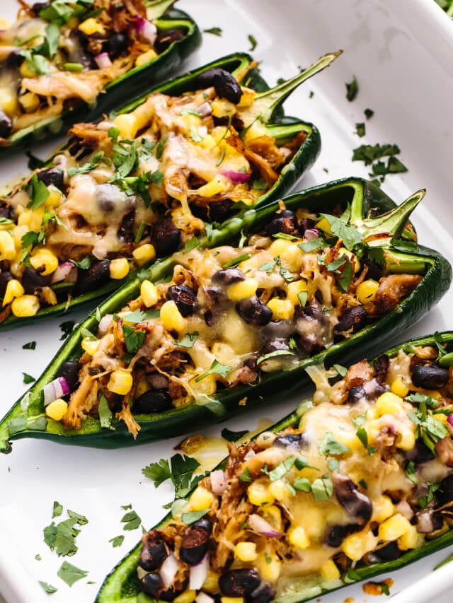 A baking dish filled with carnitas stuffed poblano peppers
