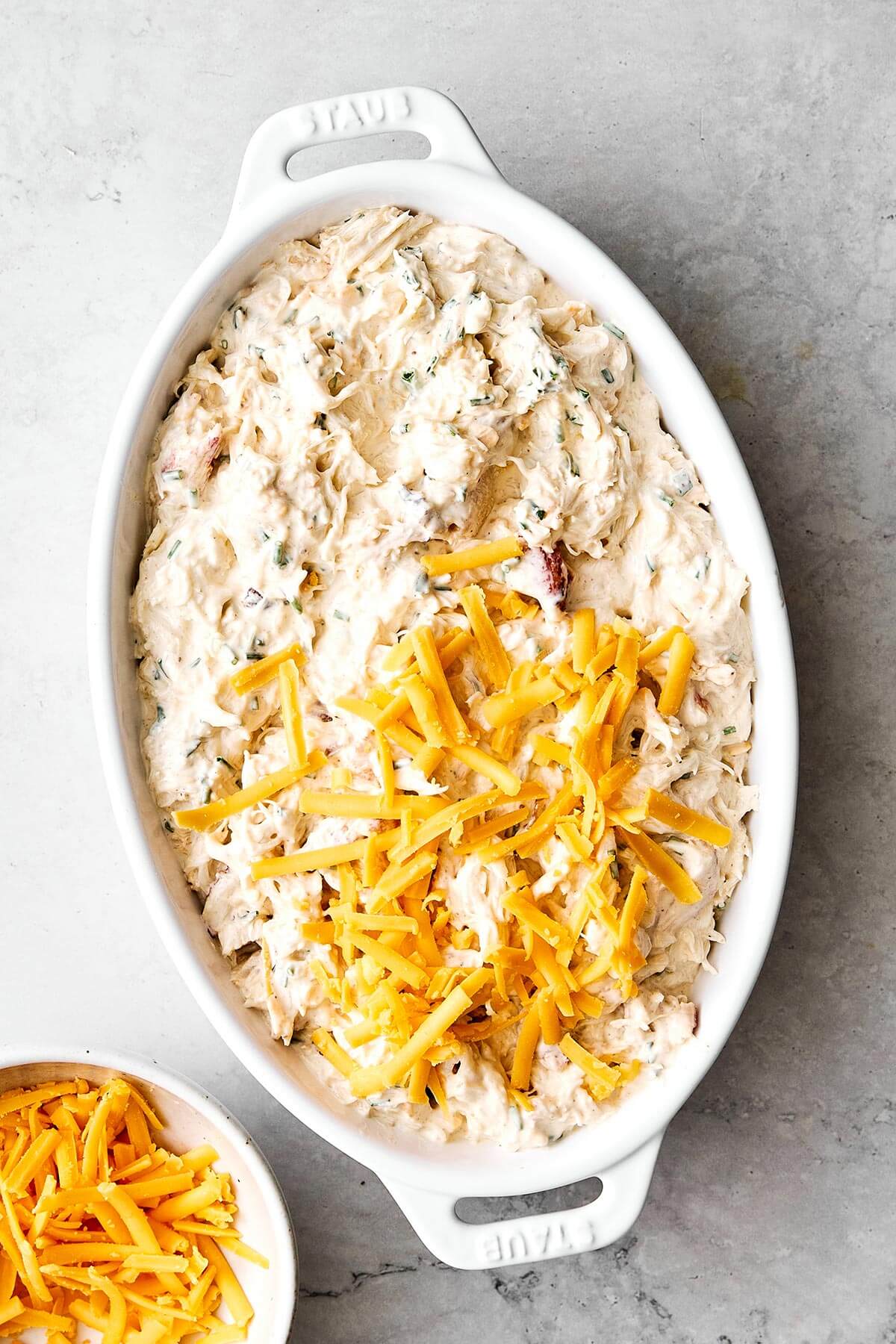Layering crab dip in baking dish.
