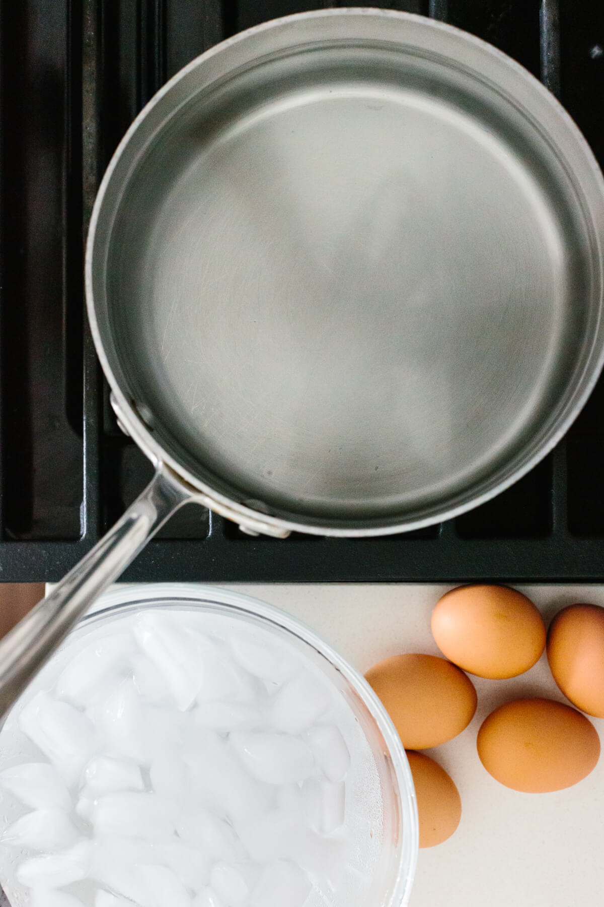A pot of hot water on the stove and an ice water bath.