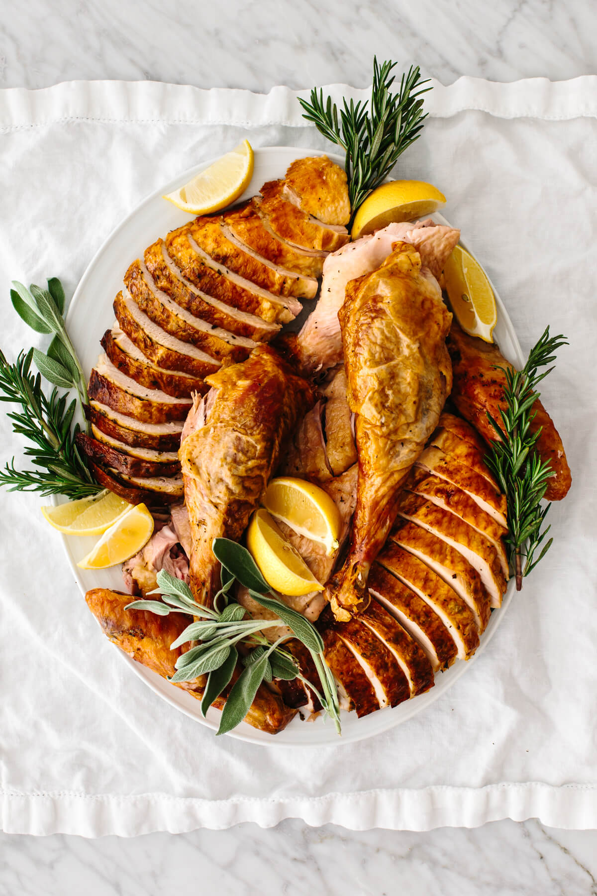 Carved turkey on a serving dish on a table.