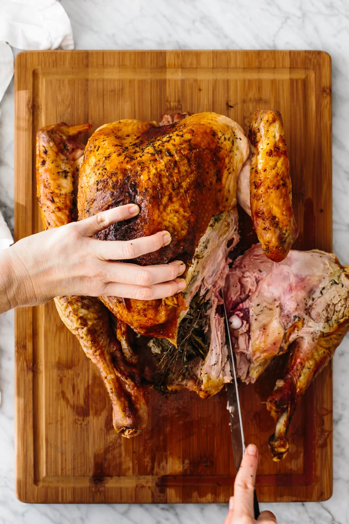 Slicing off the leg of a Thanksgiving turkey in the carving process.