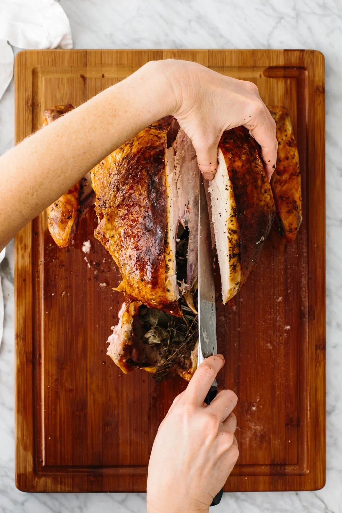Carving out the breast of a Thanksgiving turkey.