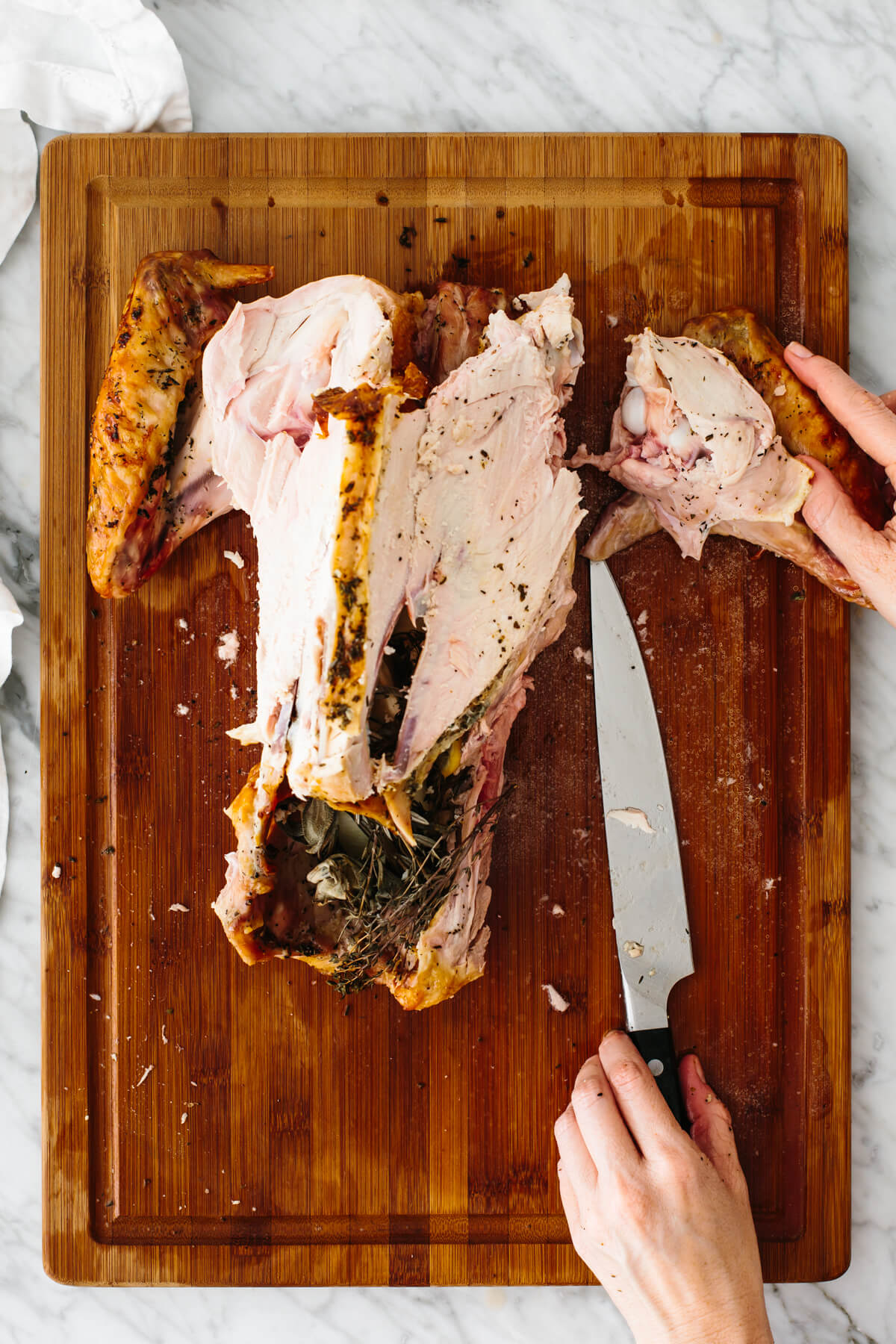 Carving out the wing tip from a turkey.