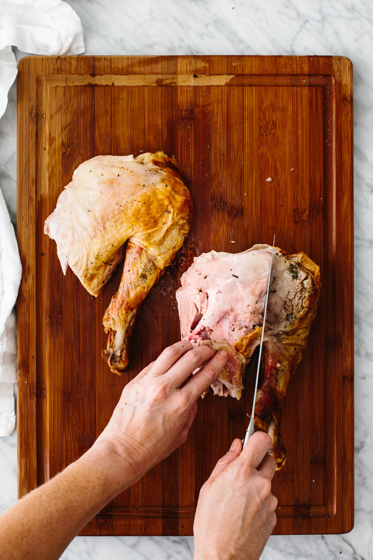 Carving out the drumstick from the thigh of a Thanksgiving turkey