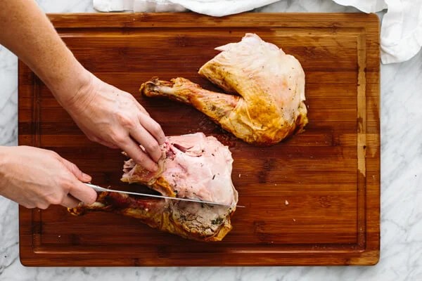 Removing the drumstick from a carved turkey.