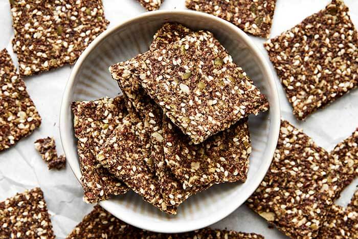A white bowl of seed crackers.