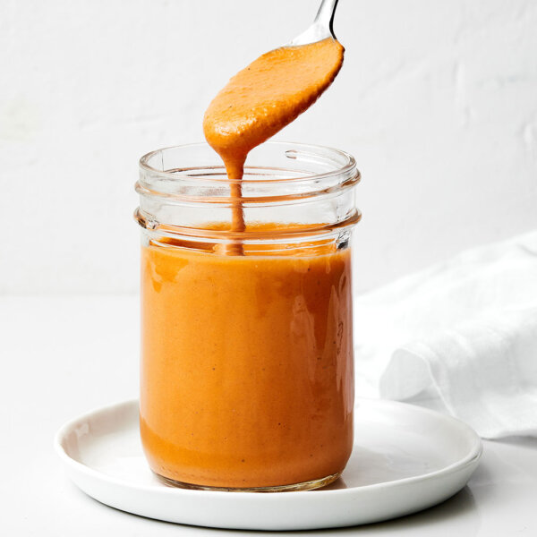 A glass jar of roasted red pepper tahini sauce