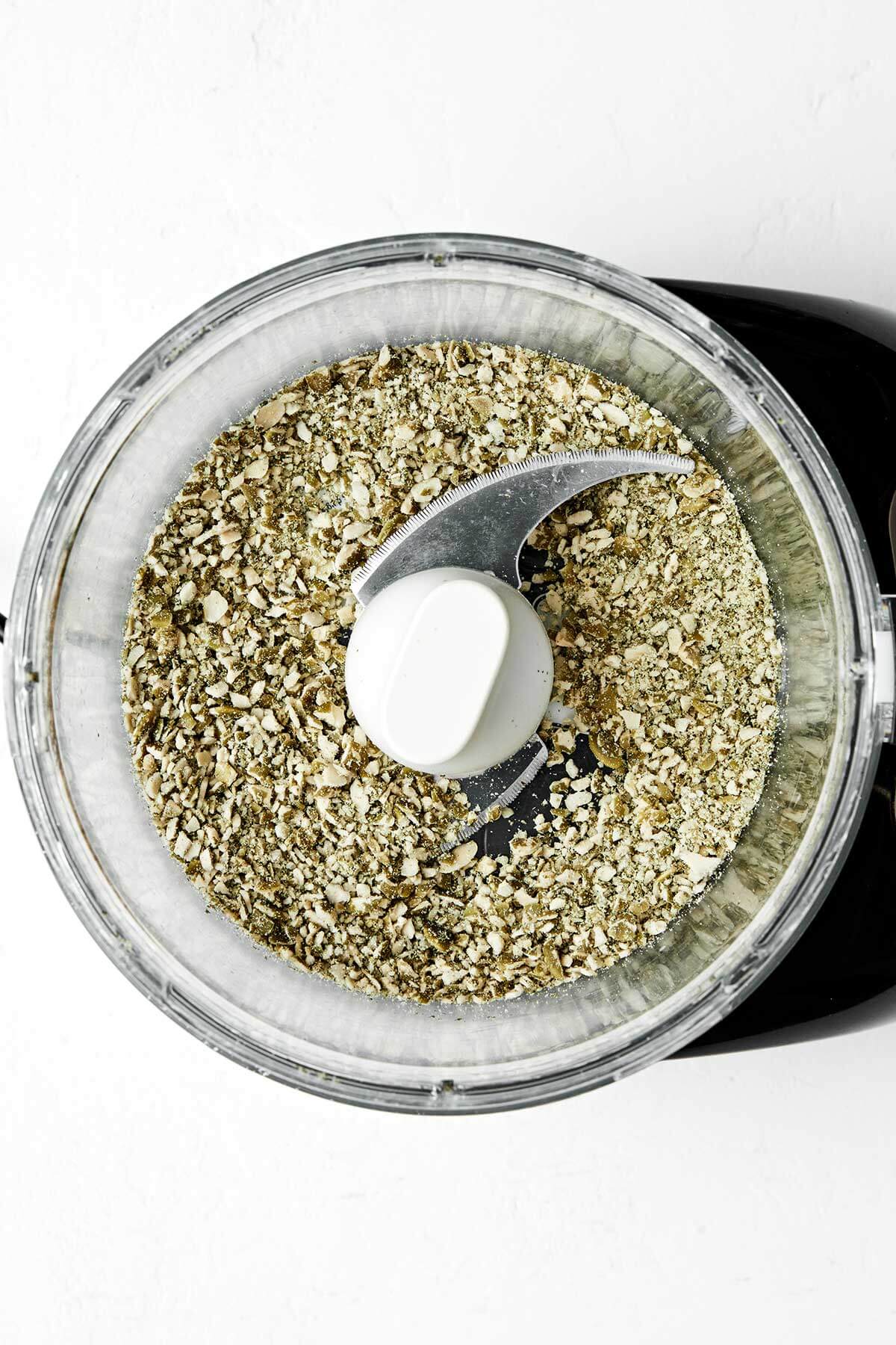 Crunchy, flavorful, and full of nutrients, these healthy seed crackers will soon be your favorite snack. Plus, they’re naturally gluten-free! Grinded pepita seeds in a food processor.