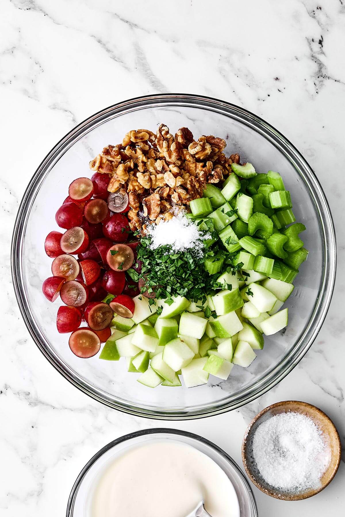 Mixing Waldorf salad in a bowl.
